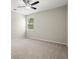 Bright bedroom featuring a window offering natural light, and carpet flooring at 4452 Thach Ave, Sugar Hill, GA 30518