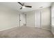 Well-lit bedroom featuring carpet flooring, neutral walls, and a ceiling fan at 4452 Thach Ave, Sugar Hill, GA 30518