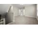 Bright bonus room with neutral carpet, offering flexible living space for various activities and relaxation at 4452 Thach Ave, Sugar Hill, GA 30518