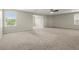 Large carpeted bonus room with plenty of natural light and a ceiling fan at 4452 Thach Ave, Sugar Hill, GA 30518