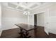 Dining room with coffered ceilings, dark wood floors, and double doors at 4452 Thach Ave, Sugar Hill, GA 30518