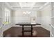 Formal dining room with coffered ceiling, dark wood floors, and wainscoting at 4452 Thach Ave, Sugar Hill, GA 30518