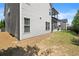 Home exterior with landscaped lawn, backyard, and screened-in porch at 4452 Thach Ave, Sugar Hill, GA 30518