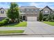 Charming two-story home featuring a stone and siding facade, a two-car garage, and a well-manicured lawn at 4452 Thach Ave, Sugar Hill, GA 30518