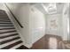Inviting foyer with hardwood flooring, staircase, and decorative wainscoting at 4452 Thach Ave, Sugar Hill, GA 30518