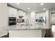 Kitchen island featuring granite countertops, stainless steel sink, and ample workspace at 4452 Thach Ave, Sugar Hill, GA 30518