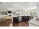 Spacious open-concept kitchen with a granite island, seamlessly connected to the living area at 4452 Thach Ave, Sugar Hill, GA 30518