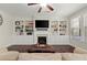 Inviting living room with custom built-ins, fireplace, and ceiling fan at 4452 Thach Ave, Sugar Hill, GA 30518