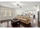 Cozy living room featuring a comfortable sofa and seamless transition to the kitchen and dining area at 4452 Thach Ave, Sugar Hill, GA 30518
