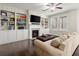Spacious living room featuring custom built-ins, fireplace, and hardwood floors at 4452 Thach Ave, Sugar Hill, GA 30518