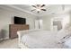 Comfortable bedroom featuring tray ceiling and an ensuite bathroom with a glass enclosed shower at 4452 Thach Ave, Sugar Hill, GA 30518