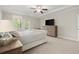 Lovely main bedroom with ceiling fan and access to balcony, and neutral decor at 4452 Thach Ave, Sugar Hill, GA 30518
