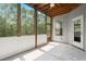 Bright screened-in porch featuring a ceiling fan, white trim, and an exterior door at 4452 Thach Ave, Sugar Hill, GA 30518