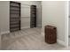 Spacious walk-in closet with shelving units and ample storage space, complemented by neutral carpeting at 4452 Thach Ave, Sugar Hill, GA 30518