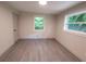 Bright bedroom features neutral colors, a modern door, and a large window view at 2926 Monterey Dr, Decatur, GA 30032