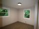 A clean, blank bedroom awaits your personal touch, featuring wood floors and natural light from the room's two windows at 2926 Monterey Dr, Decatur, GA 30032