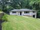 Attractive one-story home with a well-kept lawn, landscaped garden beds, and convenient garage access at 2926 Monterey Dr, Decatur, GA 30032