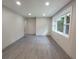 Bright living room features gray flooring, recessed lights, and a large window at 2926 Monterey Dr, Decatur, GA 30032