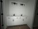Modern bathroom featuring double vanity sinks and stylish light fixtures at 1115 Lockhart Way, Douglasville, GA 30135