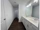 Modern bathroom featuring double vanity sinks, stylish light fixtures, and dark floors at 1115 Lockhart Way, Douglasville, GA 30135