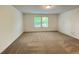 Spacious bedroom with plush carpeting and lots of natural light from large windows at 1115 Lockhart Way, Douglasville, GA 30135