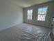 The large windows fill this carpeted bedroom with natural light at 1115 Lockhart Way, Douglasville, GA 30135
