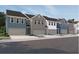 Charming exterior view of colorful townhomes with attached garages and traditional architectural details at 1115 Lockhart Way, Douglasville, GA 30135