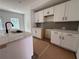 Bright kitchen features white cabinets, gray backsplash, and a marble countertop island at 1115 Lockhart Way, Douglasville, GA 30135