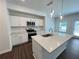 Bright kitchen with stainless steel appliances, white cabinets, and an island at 1115 Lockhart Way, Douglasville, GA 30135