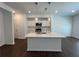 Modern kitchen featuring white cabinets, a large island, and stainless-steel appliances at 1115 Lockhart Way, Douglasville, GA 30135