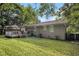 The backyard showcases a wooden deck, a well-maintained lawn, and mature trees, ideal for outdoor enjoyment at 2191 Greystone Way, Decatur, GA 30032
