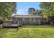 A view of a well-maintained backyard with a small wooden deck, offering ample space for outdoor relaxation at 2191 Greystone Way, Decatur, GA 30032
