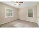 A comfortable bedroom with soft carpet, neutral walls, and windows that let in natural light at 2191 Greystone Way, Decatur, GA 30032