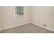 Cozy bedroom with neutral carpet and paint, plus a large window for natural light at 2191 Greystone Way, Decatur, GA 30032