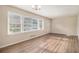 Bright living room with large windows, wood-look floors, and neutral paint is ready for its new owners at 2191 Greystone Way, Decatur, GA 30032