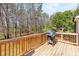 Wooden back deck featuring a grill, perfect for outdoor cooking and entertaining at 275 Cedars, Villa Rica, GA 30180