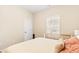 Bright bedroom featuring a bed, window, and door, offering a cozy and functional space at 275 Cedars, Villa Rica, GA 30180