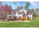 Charming two-story home with white siding and wood shutters with a lush green lawn at 275 Cedars, Villa Rica, GA 30180