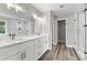 Modern bathroom featuring double vanity, a large mirror, and a glass shower at 5341 Stewart Mill Rd, Douglasville, GA 30135