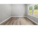 A gray bedroom with wood flooring and a view of the outside at 5341 Stewart Mill Rd, Douglasville, GA 30135