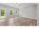 Bright bedroom featuring three large windows and a door allowing for ample natural light at 5341 Stewart Mill Rd, Douglasville, GA 30135