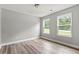 Bedroom with two windows, natural light, and wood-look flooring at 5341 Stewart Mill Rd, Douglasville, GA 30135