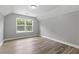 Bedroom with a window overlooking trees, and light wood-look flooring at 5341 Stewart Mill Rd, Douglasville, GA 30135