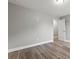 Bedroom with neutral paint, wood-look flooring, and standard closet at 5341 Stewart Mill Rd, Douglasville, GA 30135