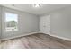 Bedroom with a window, closet, neutral paint, and wood-look flooring at 5341 Stewart Mill Rd, Douglasville, GA 30135