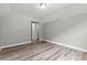 Bedroom with neutral paint, wood-look flooring, and walk-in closet access at 5341 Stewart Mill Rd, Douglasville, GA 30135