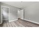 Bedroom with neutral paint, wood-look flooring, and a walk-in closet at 5341 Stewart Mill Rd, Douglasville, GA 30135