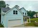 Charming two-story home featuring blue siding, a garage, and a well-manicured front lawn at 5341 Stewart Mill Rd, Douglasville, GA 30135