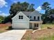 Charming two-story home with light blue accents and a well-manicured lawn in a peaceful setting at 5341 Stewart Mill Rd, Douglasville, GA 30135