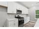 Well-equipped kitchen with stainless steel appliances, white cabinets, and modern finishes at 5341 Stewart Mill Rd, Douglasville, GA 30135
